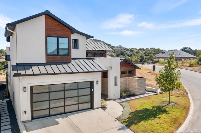 view of front of property with a garage and a front yard