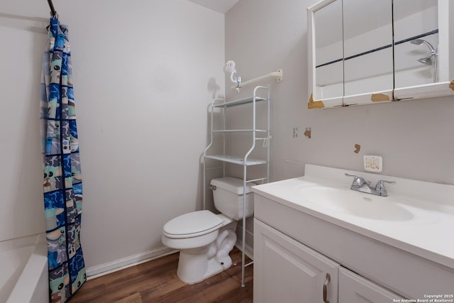 full bathroom featuring hardwood / wood-style flooring, shower / bathtub combination with curtain, vanity, and toilet