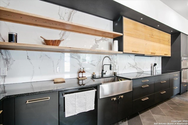 kitchen featuring tasteful backsplash, sink, dishwashing machine, dark stone counters, and black electric stovetop