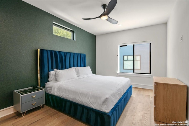 bedroom with ceiling fan and light wood-type flooring