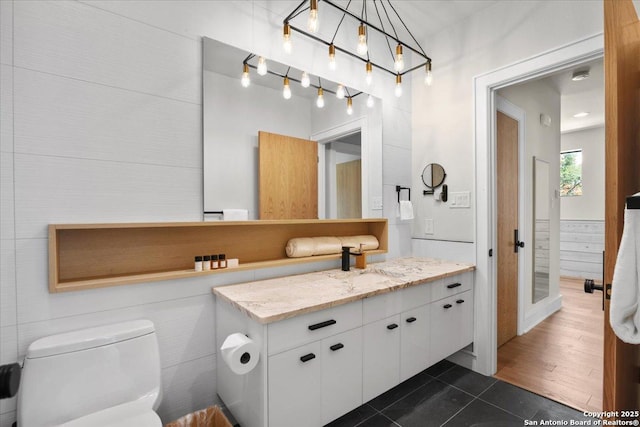 bathroom featuring vanity, tile patterned floors, and toilet