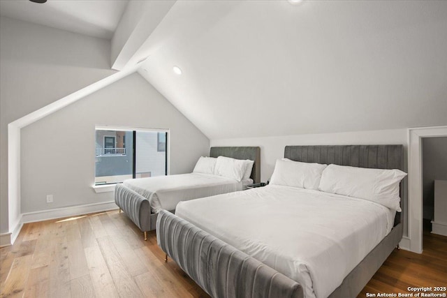 bedroom featuring lofted ceiling and hardwood / wood-style floors