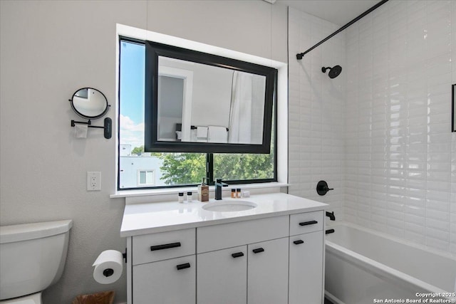 full bathroom with tiled shower / bath combo, vanity, and toilet