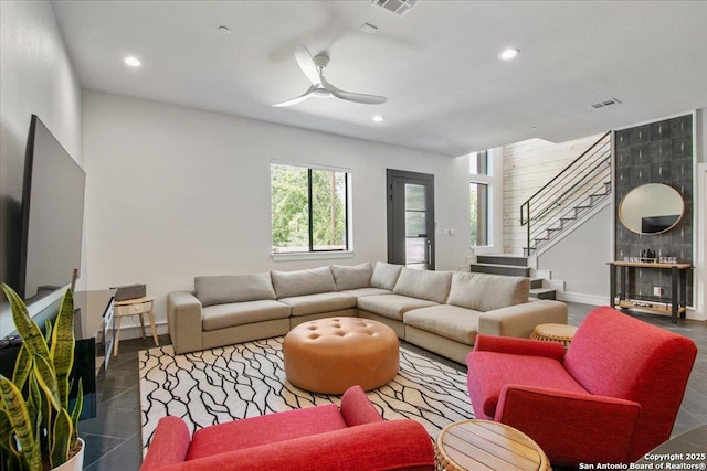 living room with dark tile patterned flooring and ceiling fan