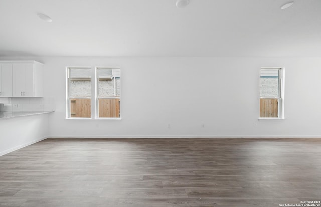 unfurnished living room featuring wood-type flooring