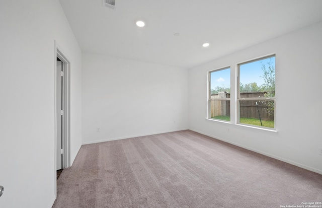 empty room featuring light carpet