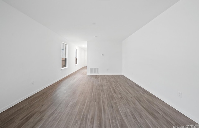 empty room with dark hardwood / wood-style flooring