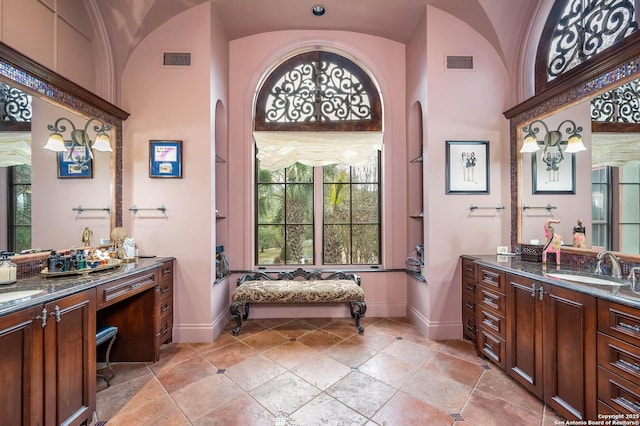 bathroom with vanity and vaulted ceiling