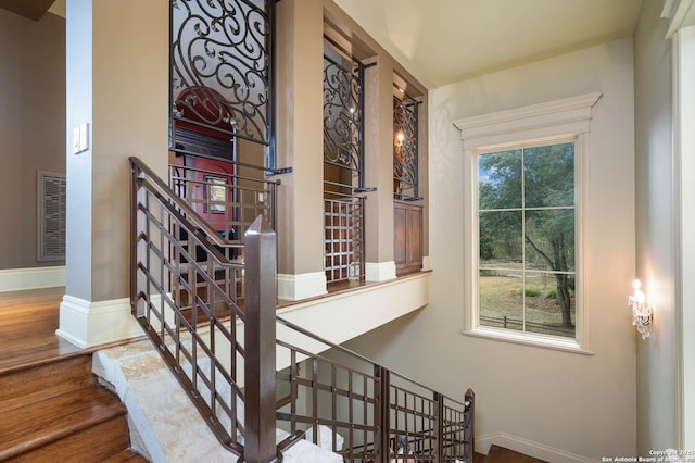 stairs featuring hardwood / wood-style floors