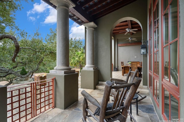 view of patio with a balcony and ceiling fan