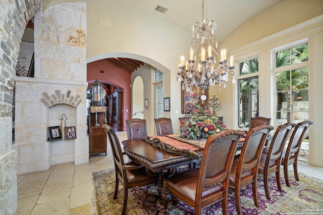 dining space featuring vaulted ceiling and a notable chandelier