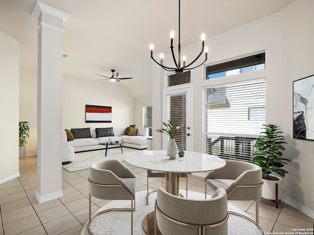 dining room with decorative columns, ceiling fan with notable chandelier, light tile patterned floors, and lofted ceiling