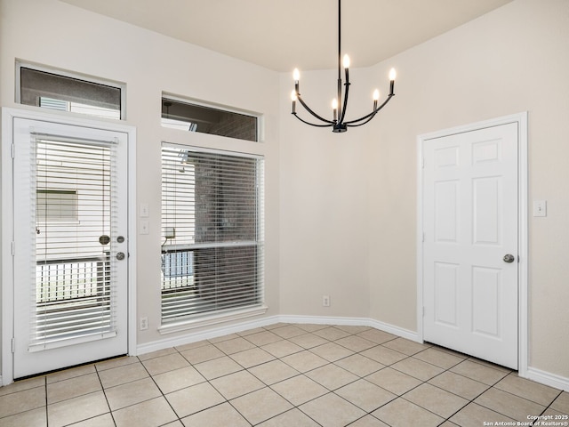 unfurnished dining area with an inviting chandelier and light tile patterned floors