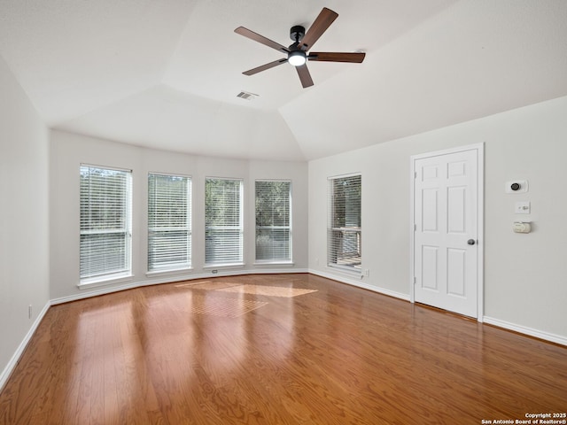 spare room with hardwood / wood-style flooring, ceiling fan, and vaulted ceiling