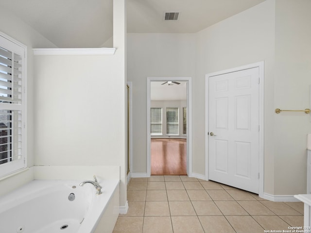 bathroom with tile patterned flooring and a bathtub