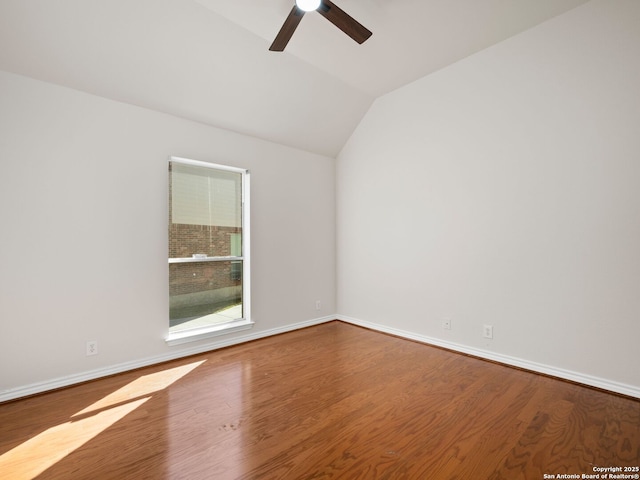 empty room featuring ceiling fan, lofted ceiling, and wood-type flooring