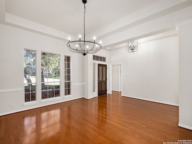 unfurnished dining area with an inviting chandelier and hardwood / wood-style floors