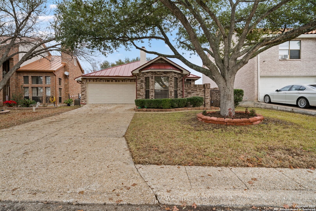 view of front of home with a garage and a front lawn