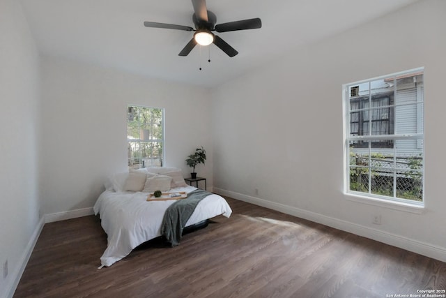 bedroom with dark wood-type flooring and ceiling fan