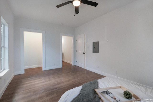 living room featuring hardwood / wood-style floors, electric panel, and ceiling fan