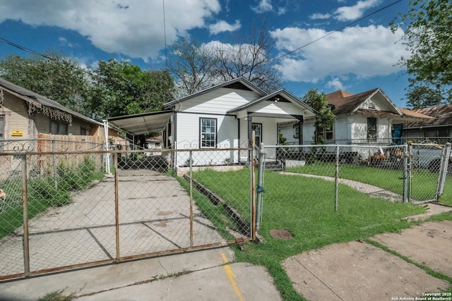 bungalow-style home with a carport and a front lawn