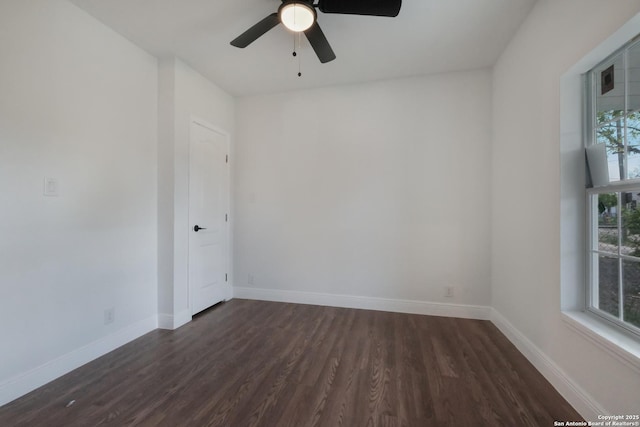 spare room with dark hardwood / wood-style flooring and ceiling fan