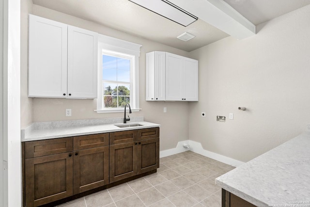 washroom featuring sink, cabinets, light tile patterned floors, washer hookup, and hookup for an electric dryer