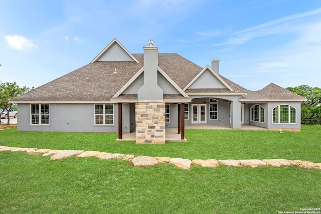 rear view of property featuring a patio and a lawn