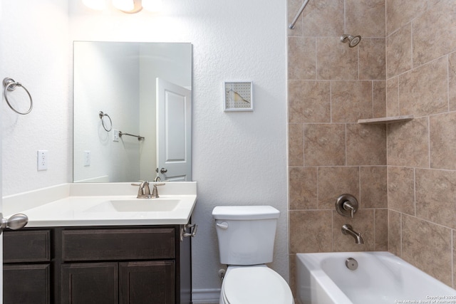 full bathroom featuring vanity, tiled shower / bath combo, and toilet