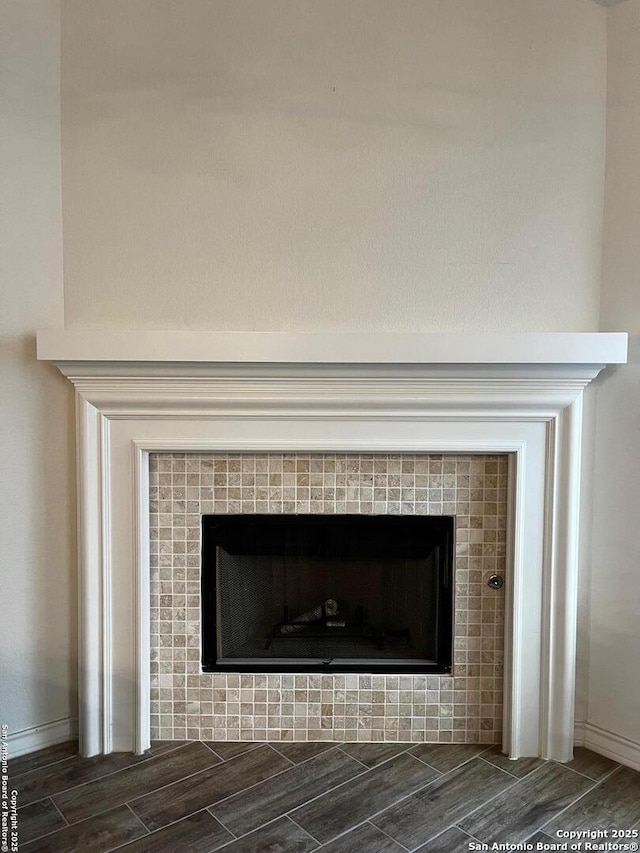 room details featuring a tile fireplace