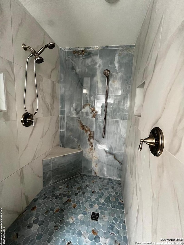 bathroom with a tile shower