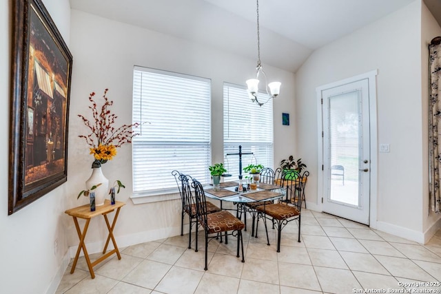 tiled dining area with lofted ceiling and a notable chandelier