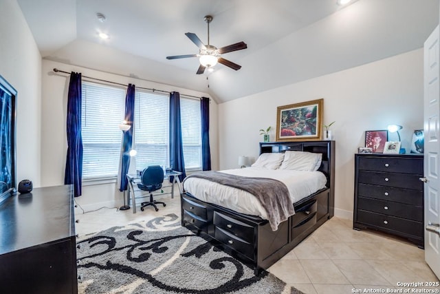 bedroom featuring lofted ceiling, light tile patterned floors, and ceiling fan