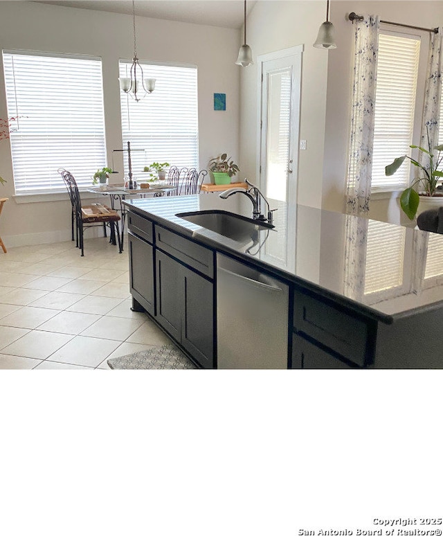 kitchen featuring sink, light tile patterned floors, plenty of natural light, dishwasher, and pendant lighting