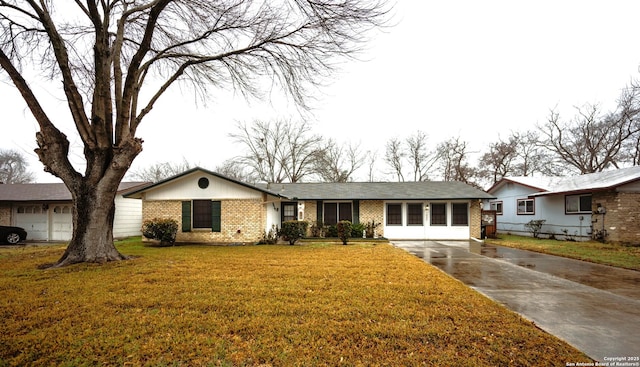 single story home with a garage and a front lawn