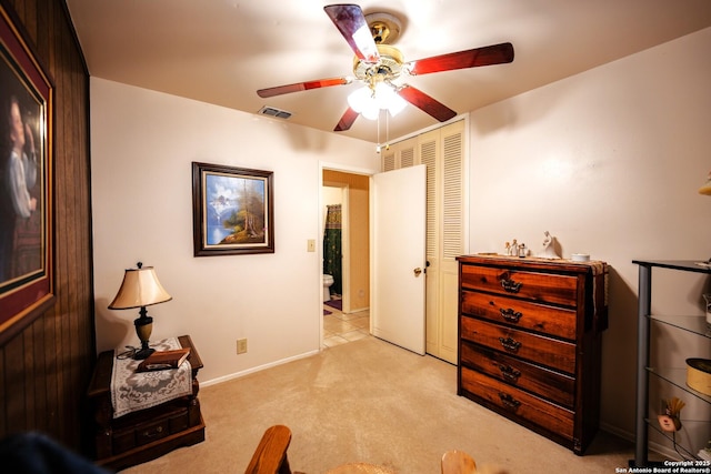 interior space with ceiling fan and a closet