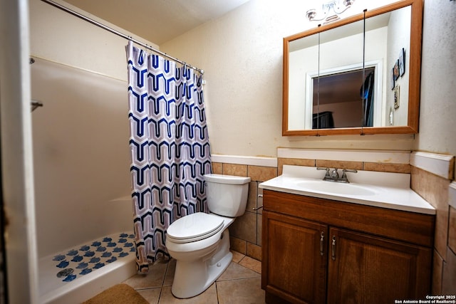 bathroom featuring tile walls, vanity, walk in shower, toilet, and tile patterned floors