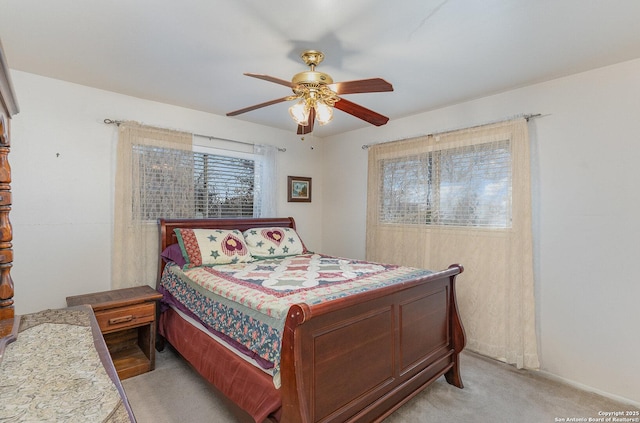 bedroom featuring ceiling fan and light colored carpet