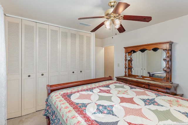 carpeted bedroom featuring a closet and ceiling fan