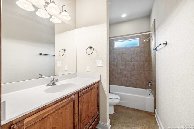 full bathroom with vanity, tiled shower / bath combo, and toilet