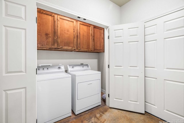 laundry room with cabinets and washer and dryer