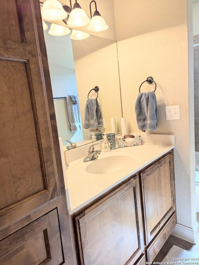 bathroom featuring an inviting chandelier and vanity