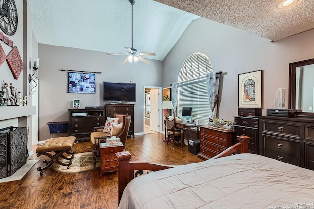 bedroom with hardwood / wood-style flooring, vaulted ceiling, and a textured ceiling