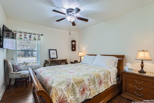 bedroom featuring dark hardwood / wood-style flooring, ceiling fan, and a textured ceiling