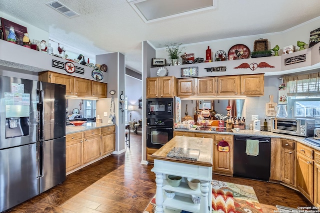 kitchen featuring crown molding, dark wood-type flooring, black appliances, and a textured ceiling