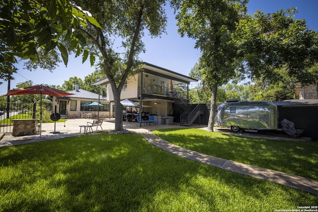 view of yard featuring a balcony and a patio