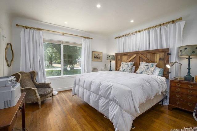 bedroom with dark hardwood / wood-style flooring