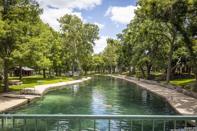 view of home's community featuring a water view and a yard