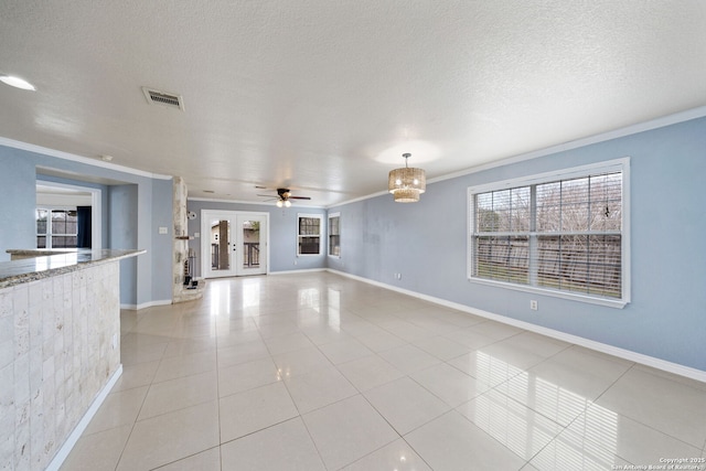 unfurnished living room featuring crown molding, a wealth of natural light, and light tile patterned floors