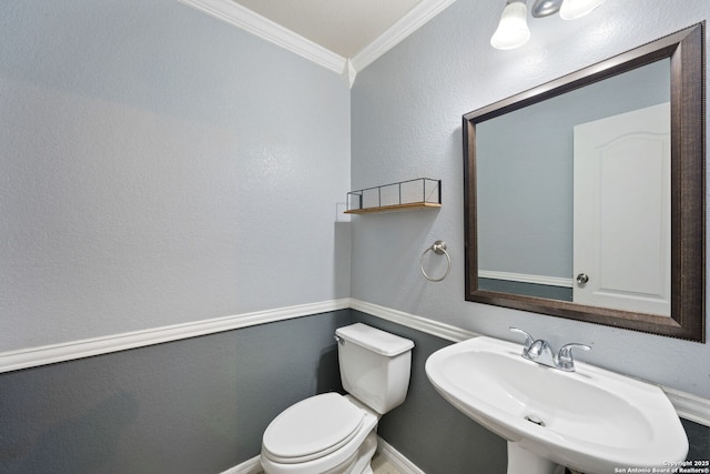 bathroom featuring ornamental molding, sink, and toilet